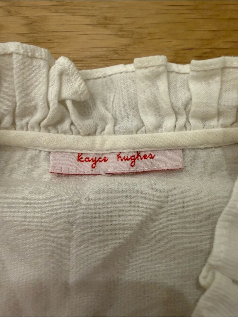Kayce Hughes white long sleeve ruffle blouse